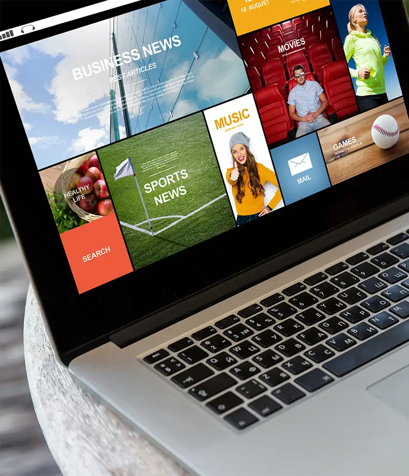 laptop open with app tiles showing