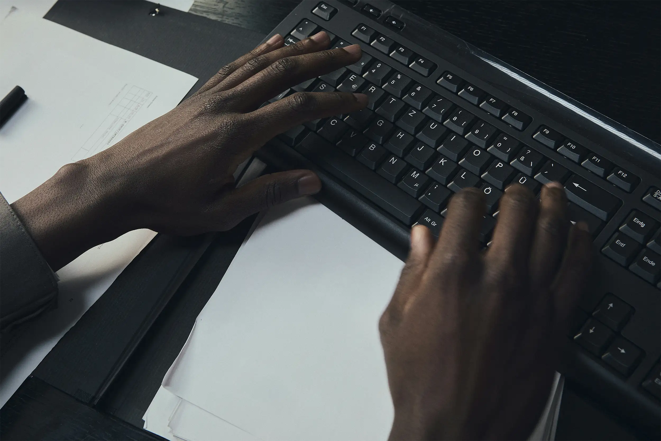 person typing on keyboard