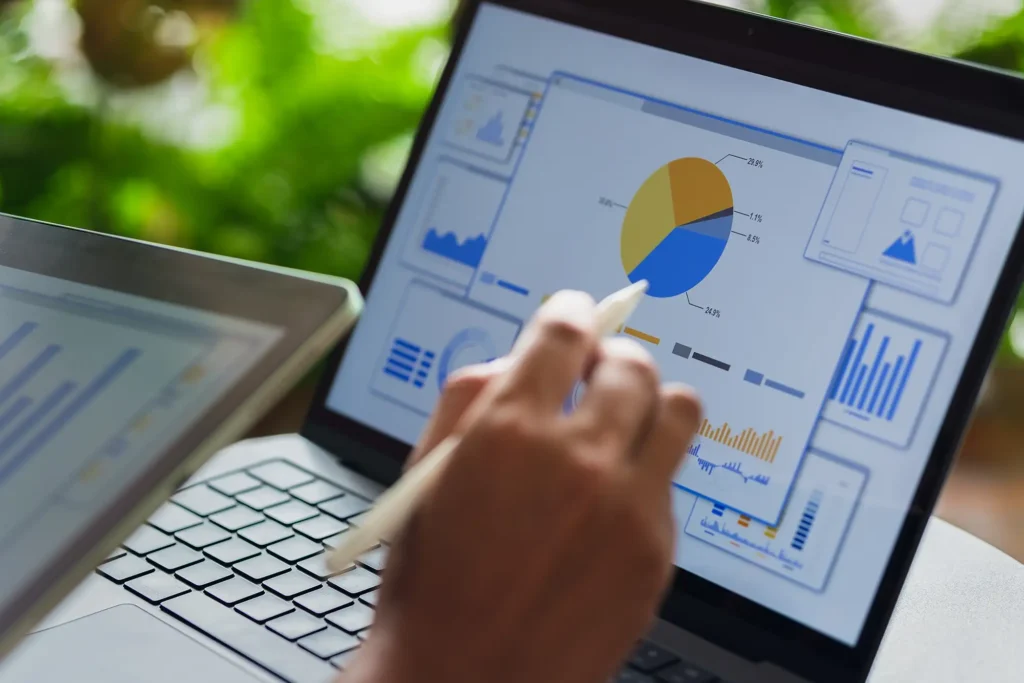 person with open laptop using stylus