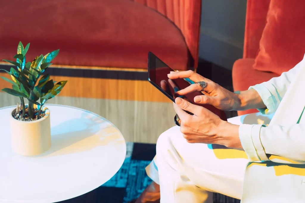 person sitting and using a tablet