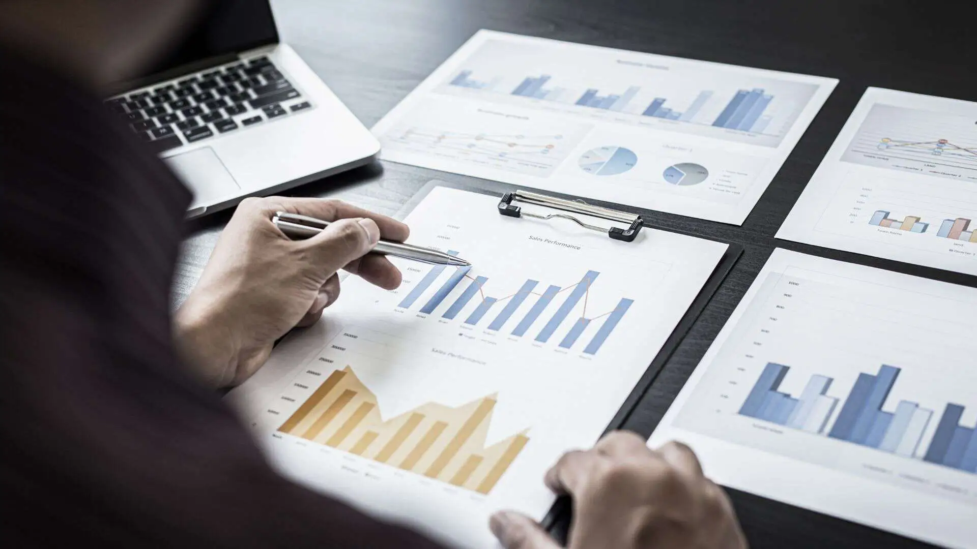 desk with clipboard and charts and graphs