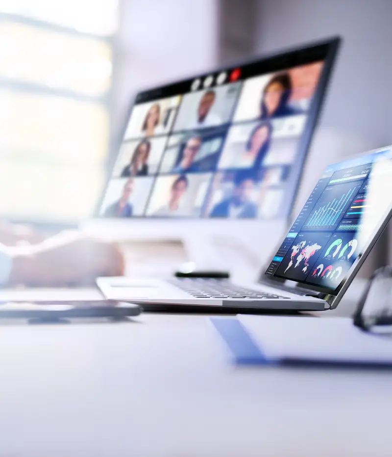 person working from laptop and computer