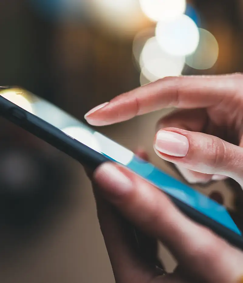woman's hand scrolling on phone