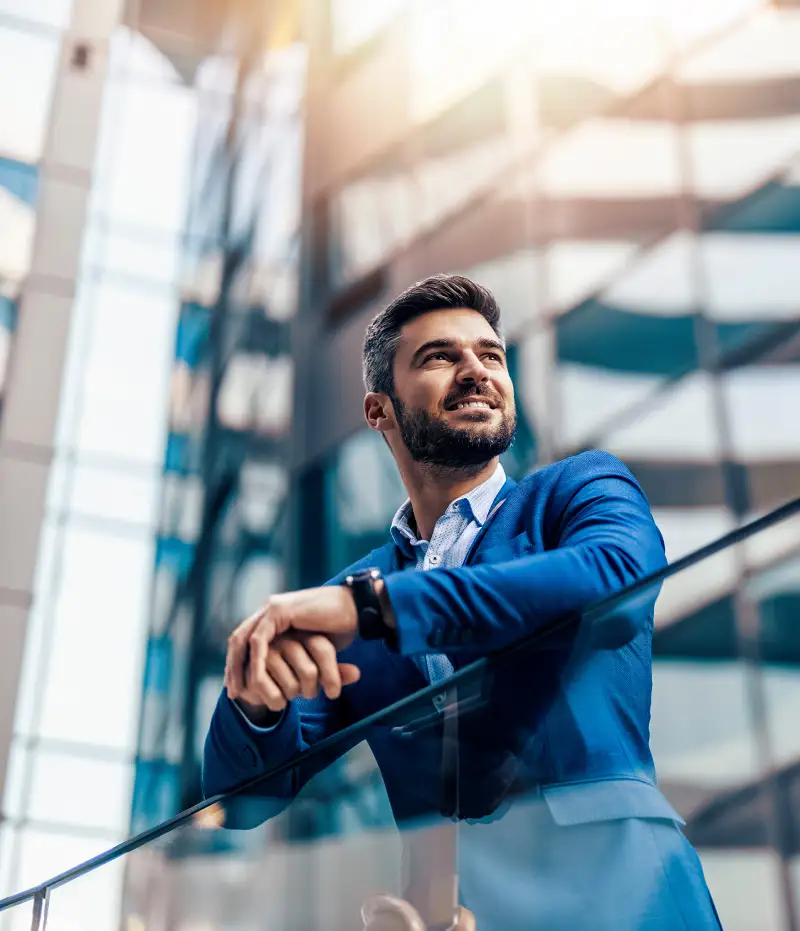 man in a suit standing by buildings