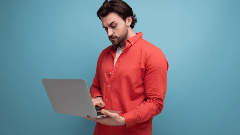 man on a laptop against blue background