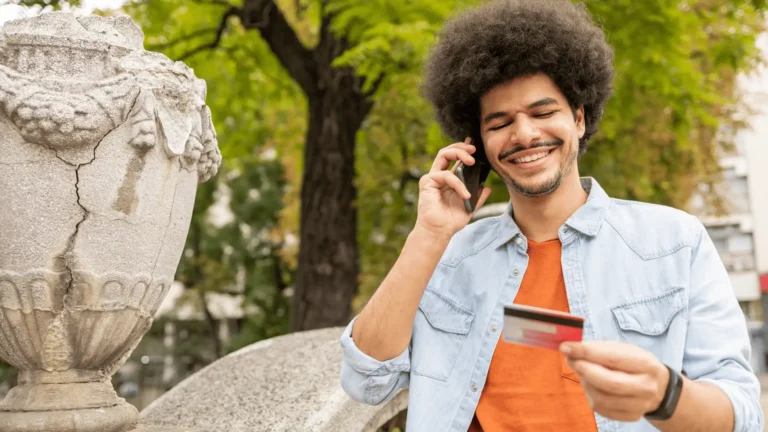 man on the phone holding a card