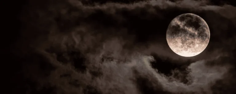 dark night with bright moon and swirling clouds