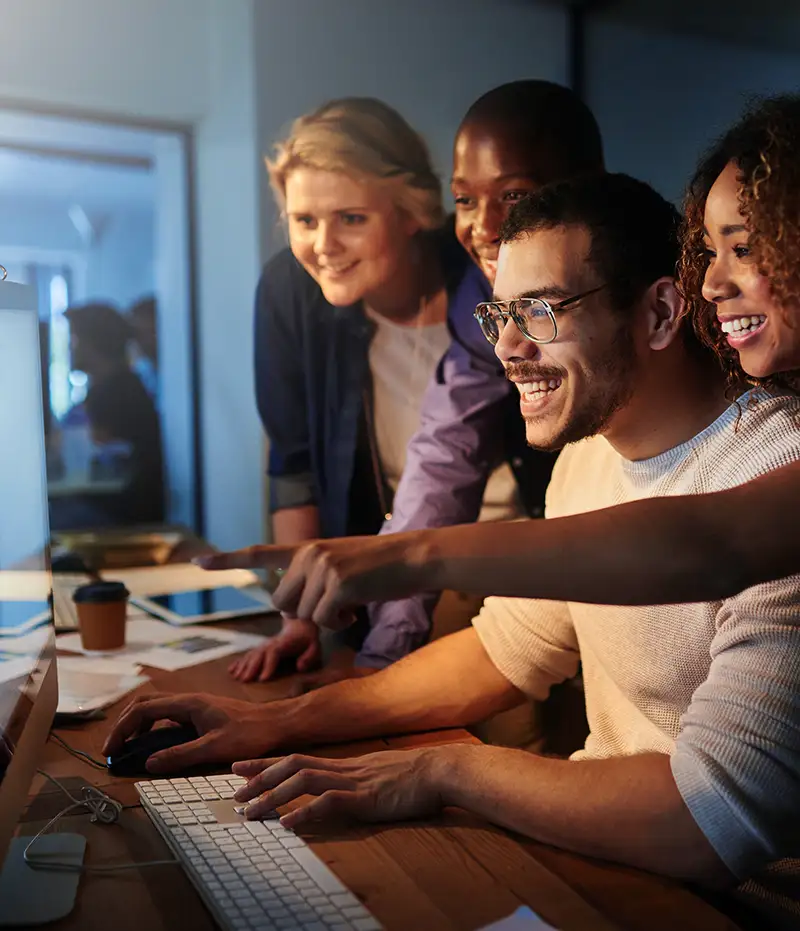 group of people excited at a computer