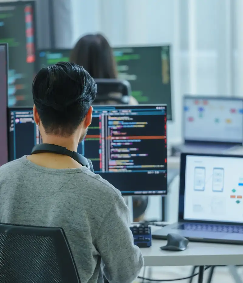 person in front of multiple computers