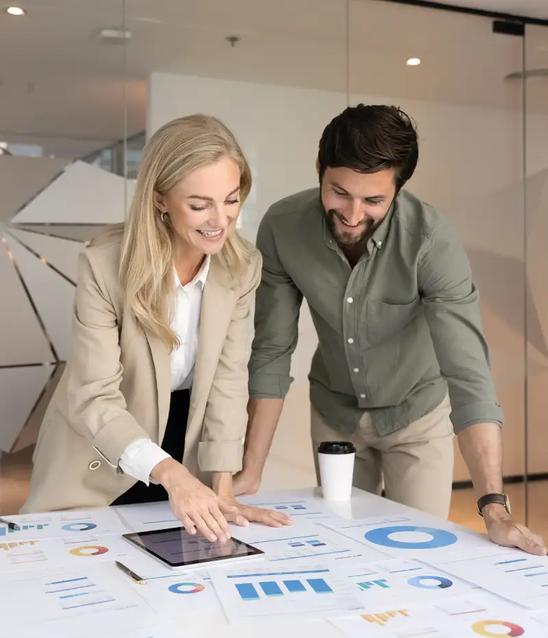 two people looking at graphs at a table