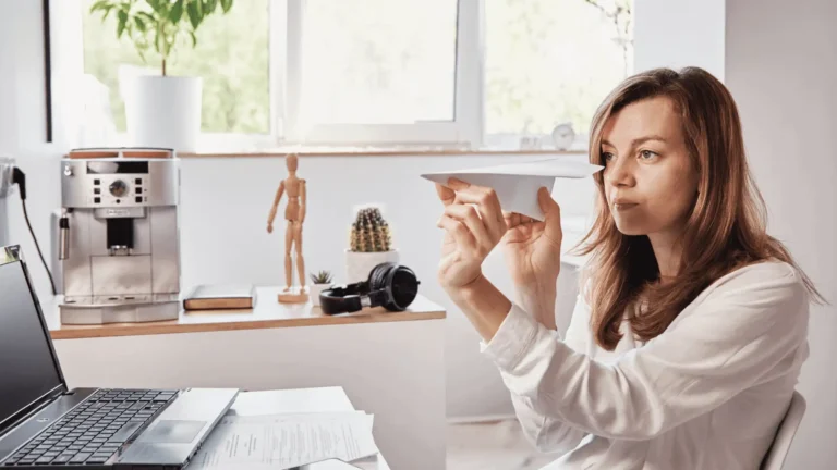 woman holding a paper airplane