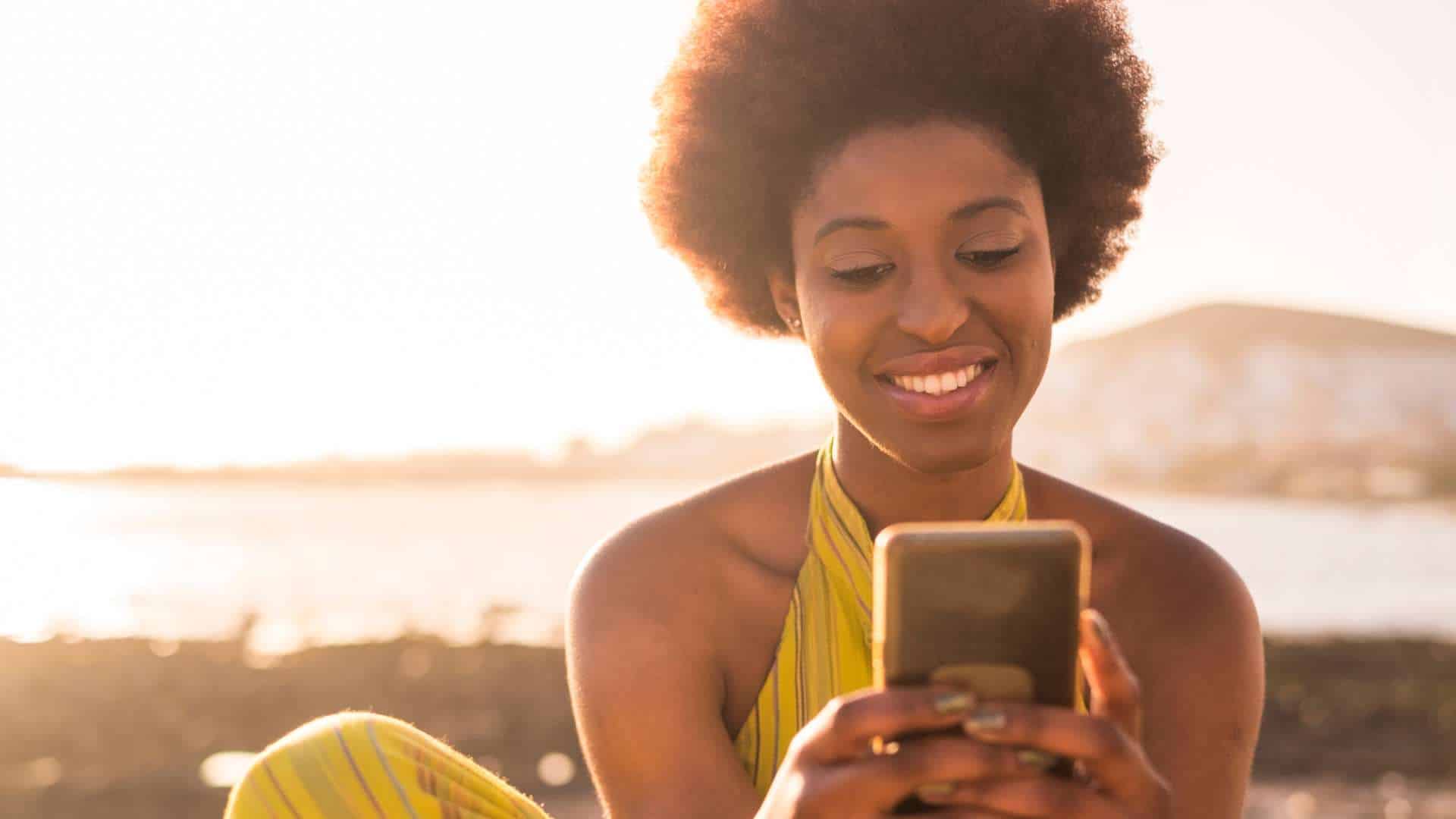 woman on the phone at the beach