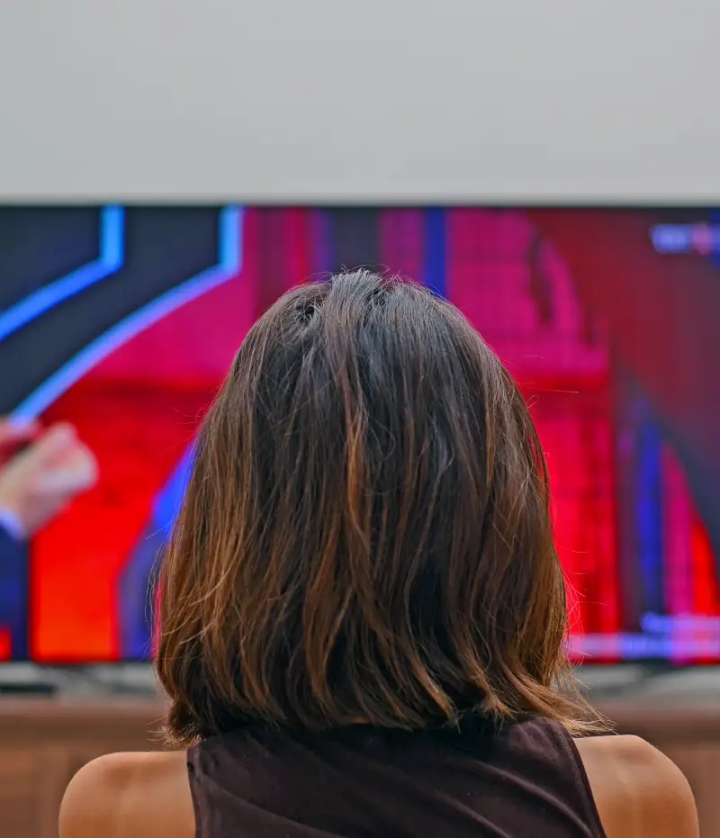 woman sitting in front of a TV