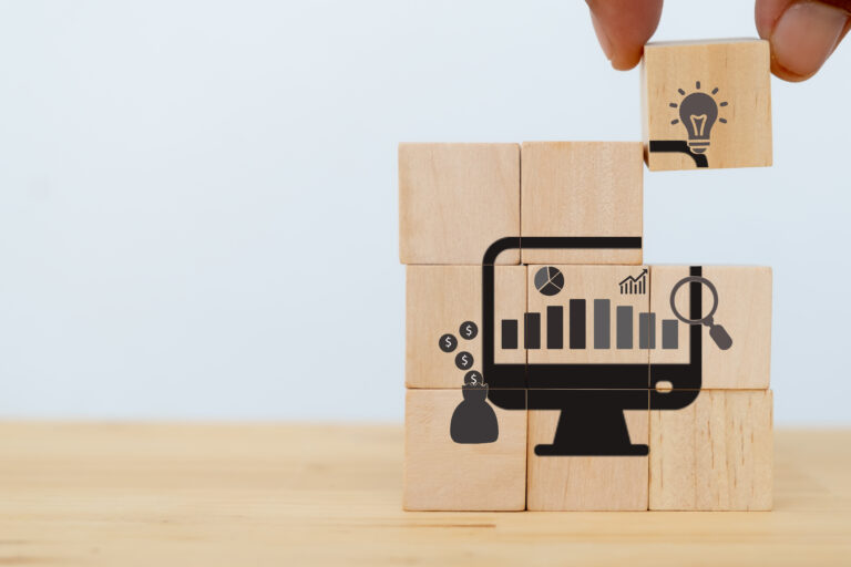 Data driven marketing concept. Businessman puts wooden cubes with data driven icons on white background and copy space