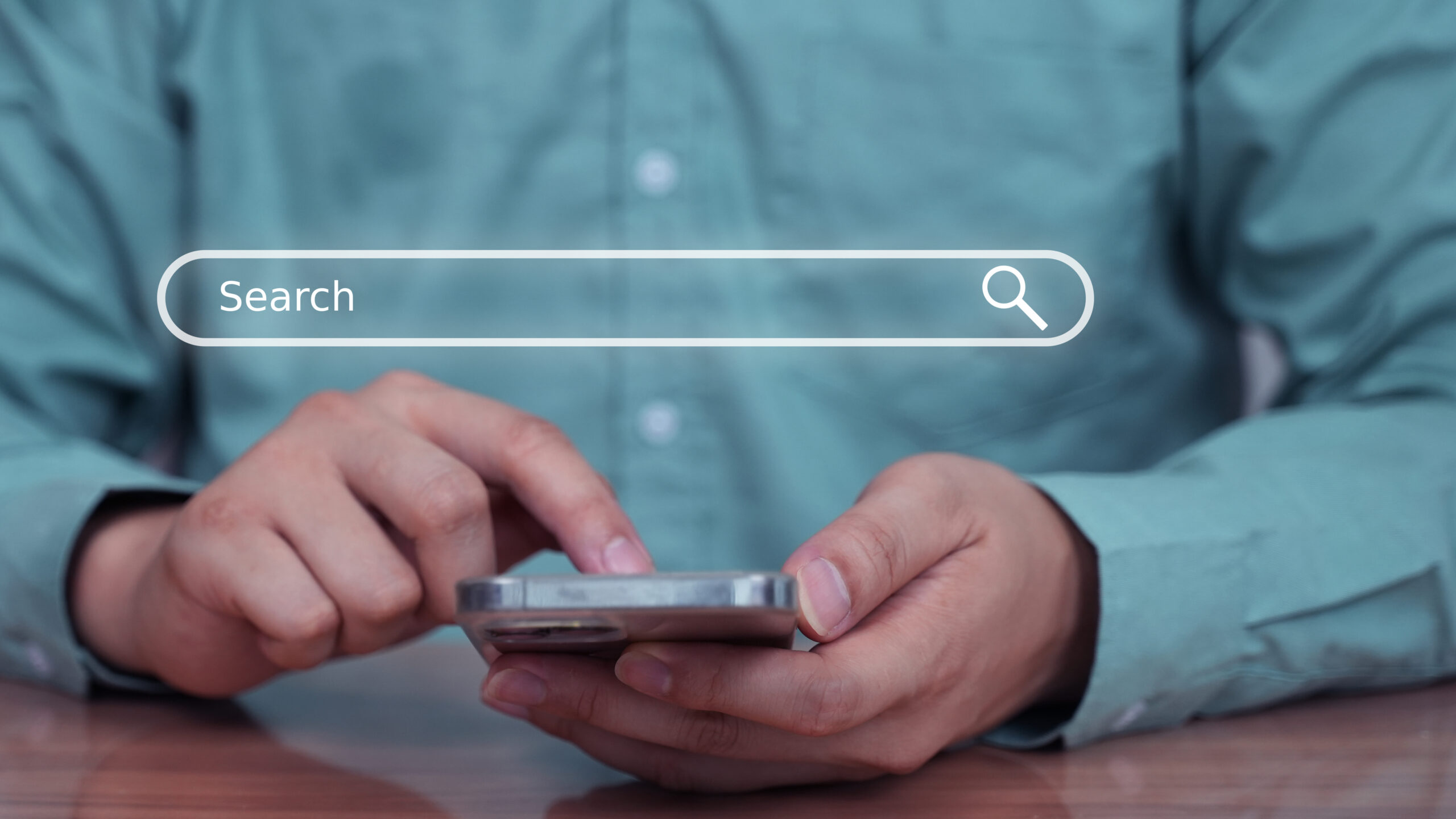 man scrolling on phone with search bar overlay